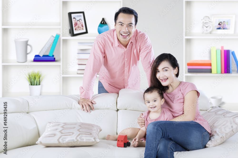 Cute girl playing toy with parents Cute girl playing toy with parents