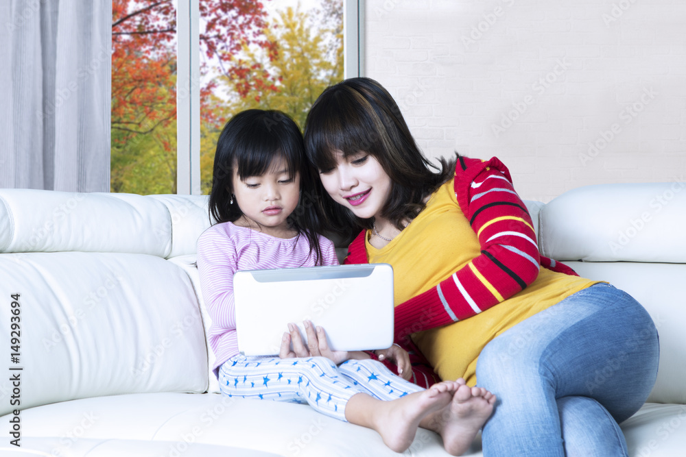 Cute mother and daughter use tablet Cute mother and daughter use tablet