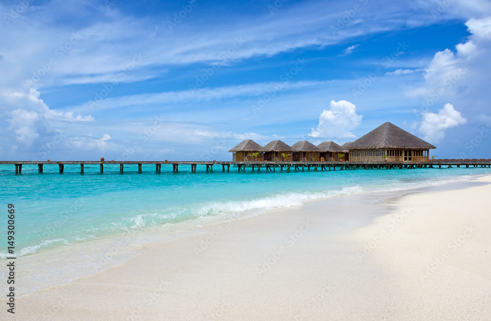 Water bungalows over blue ocean