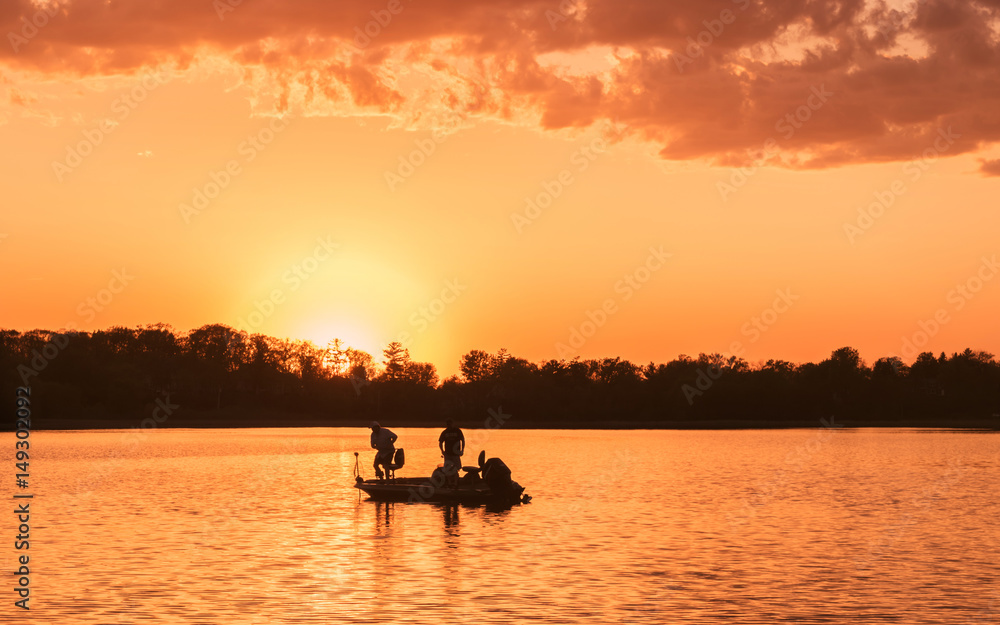 People are boating and fishing under sunset People are boating and fishing under sunset