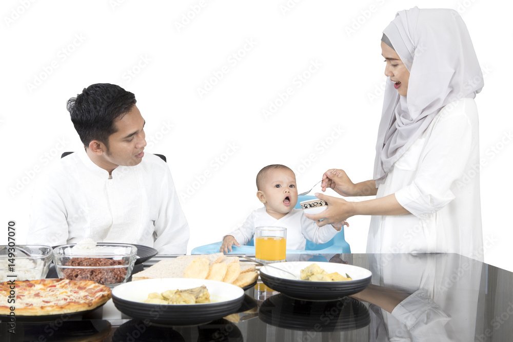 Mother feeding daughter with spoon Mother feeding daughter with spoon