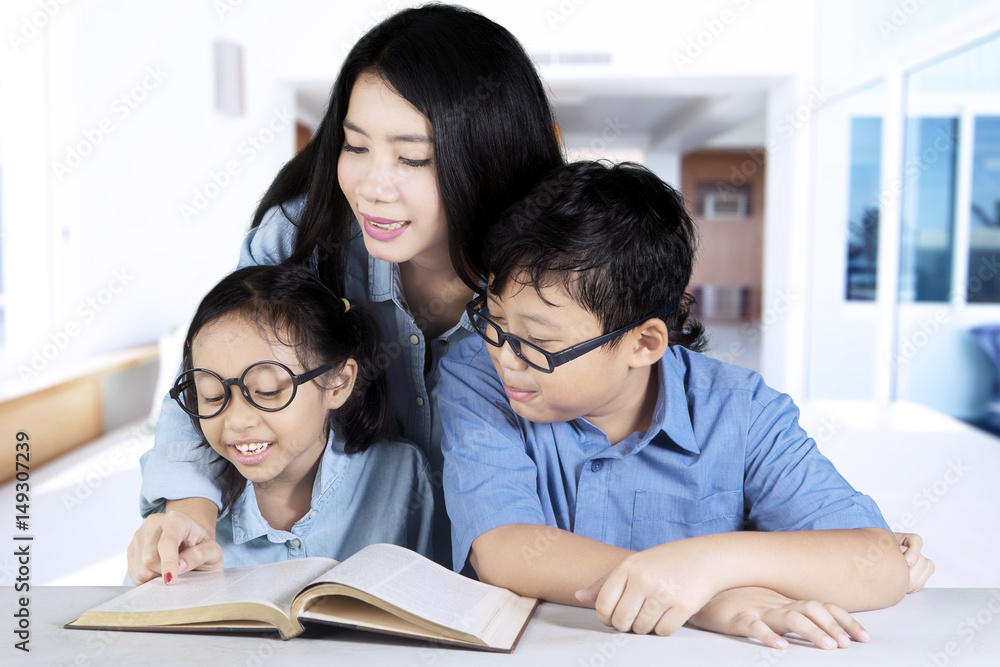 Mother guides her children to study at home Mother guides her children to study at home