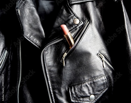 Pink lipstick in a pocket of a studded jacket photo