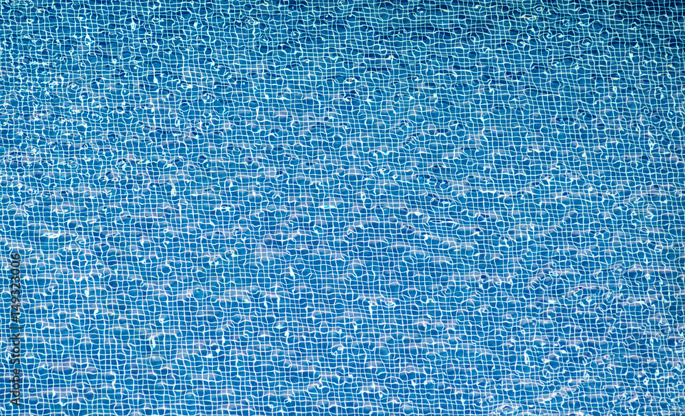Water ripples over blue tiled floor of swimming pool, View from above