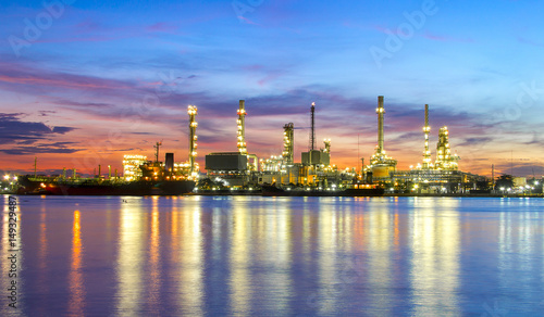 oil refinery industry plant along twilight morning pink sky