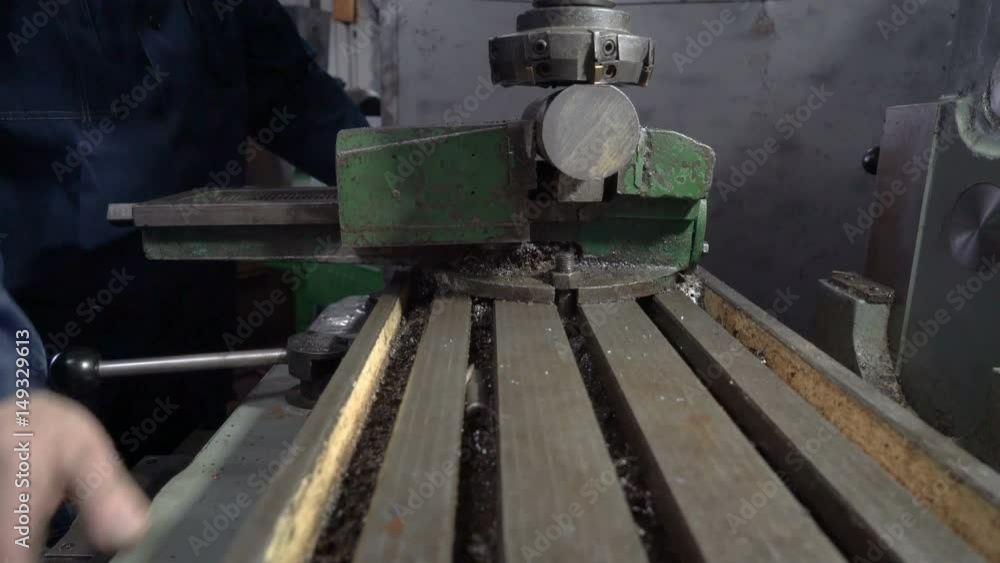 Milling machine. The worker sets the workpiece. Milling machine. The worker sets the workpiece.