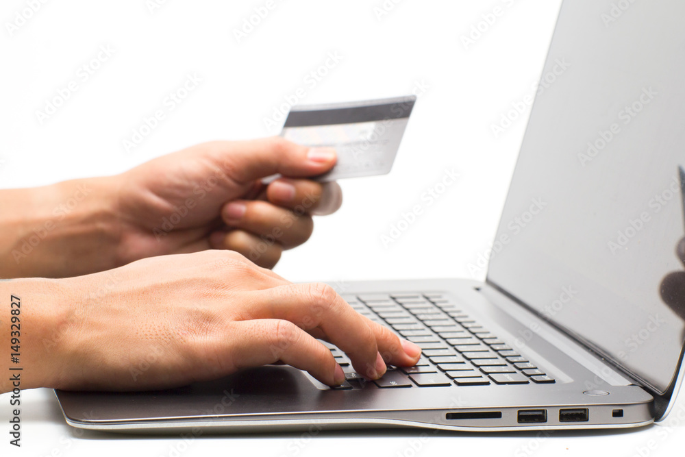 Hands holding credit card and using laptop. Online shopping Hands holding credit card and using laptop. Online shopping
