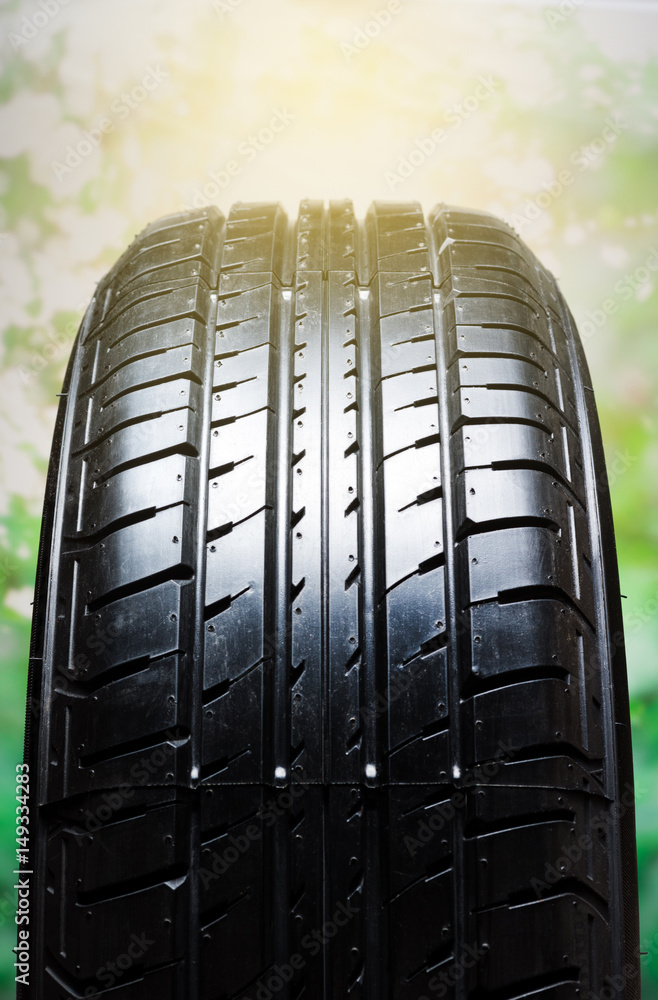 old car tyre close up with sunrise behind the bush at back old car tyre close up with sunrise behind the bush at back