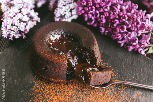 Konstfotografi Classic chocolate fondant on a dark background with flowers