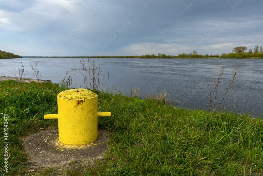 Yellow ferry anchorage point on the bank of the Vistula river near Gniew in Poland.
