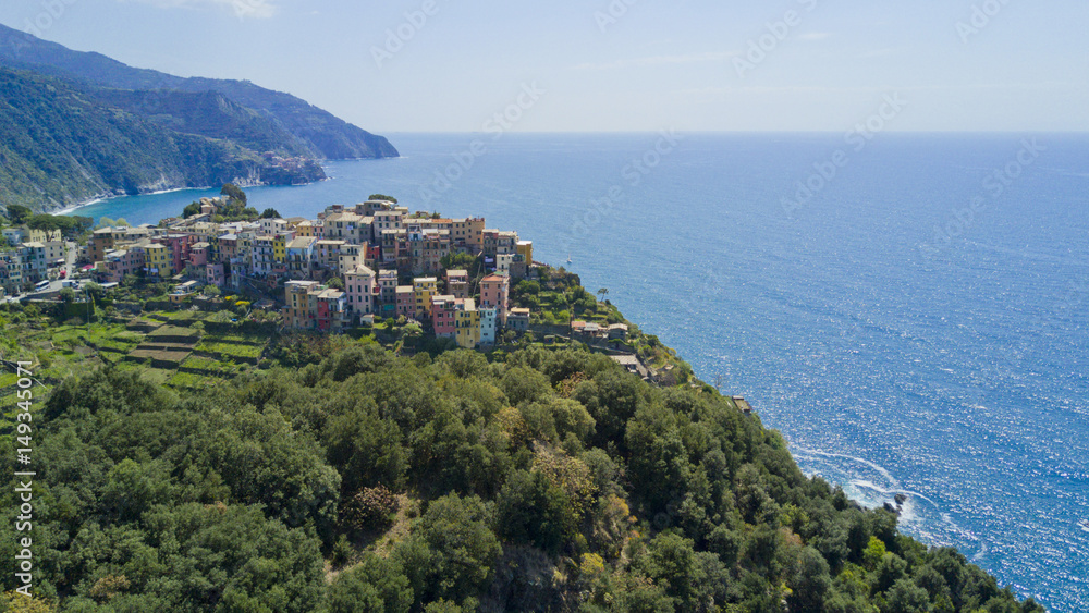 Aerial photo shooting with drone on Corniglia, one of the famous Cinqueterre country, small village with colored houses on the cliff over the sea