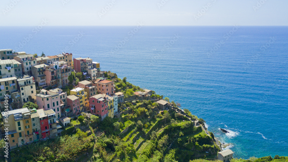 Aerial photo shooting with drone on Corniglia, one of the famous Cinqueterre country, small village with colored houses on the cliff over the sea
