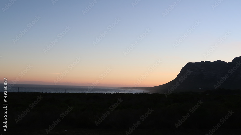 Sun Setting Behind the Mountain over the Ocean