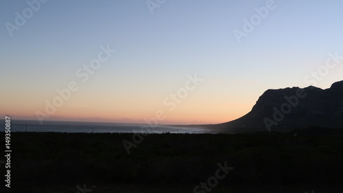 Sun Setting Behind the Mountain over the Ocean