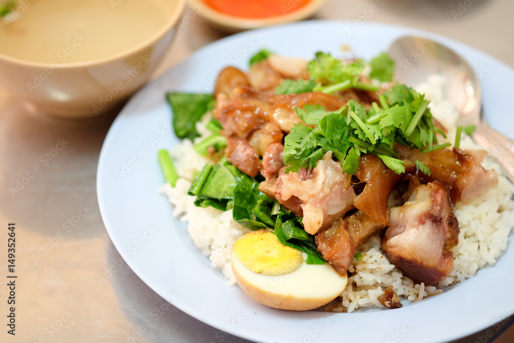 Stewed pork leg with egg and on rice on the table Stewed pork leg with egg and on rice on the table