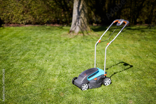 Lawn mower in the garden after mowing