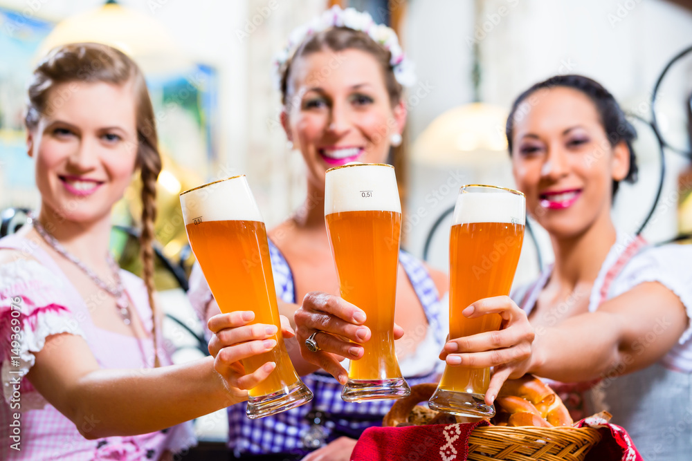 Group of people with wheat beer in Bavarian pub Group of people with wheat beer in Bavarian pub