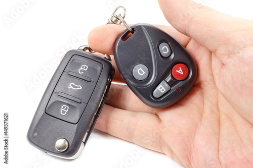 Man holds in hand ignition key and garage door remote control photo