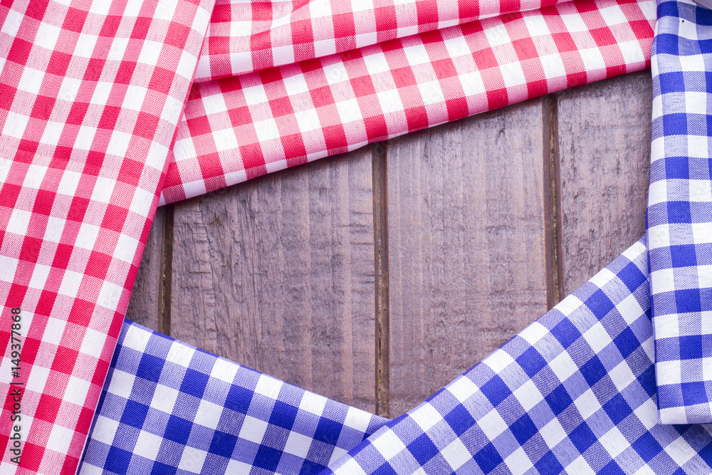 Red and blue table cloth on wooden background Red and blue table cloth on wooden background