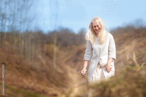 Young girl walks in the park. Spring. Outdoor. Copy space. © Natalia