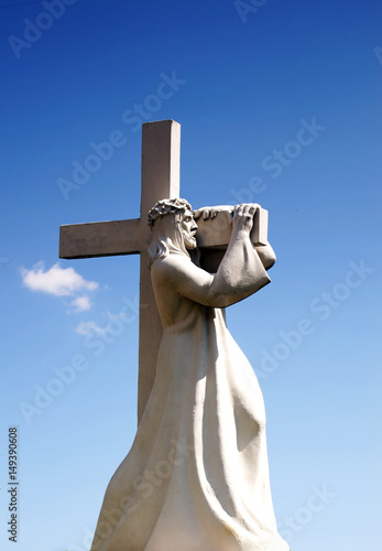 A statue of Jesus Christ carrying his cross. Jesus Christ going to Calvary.