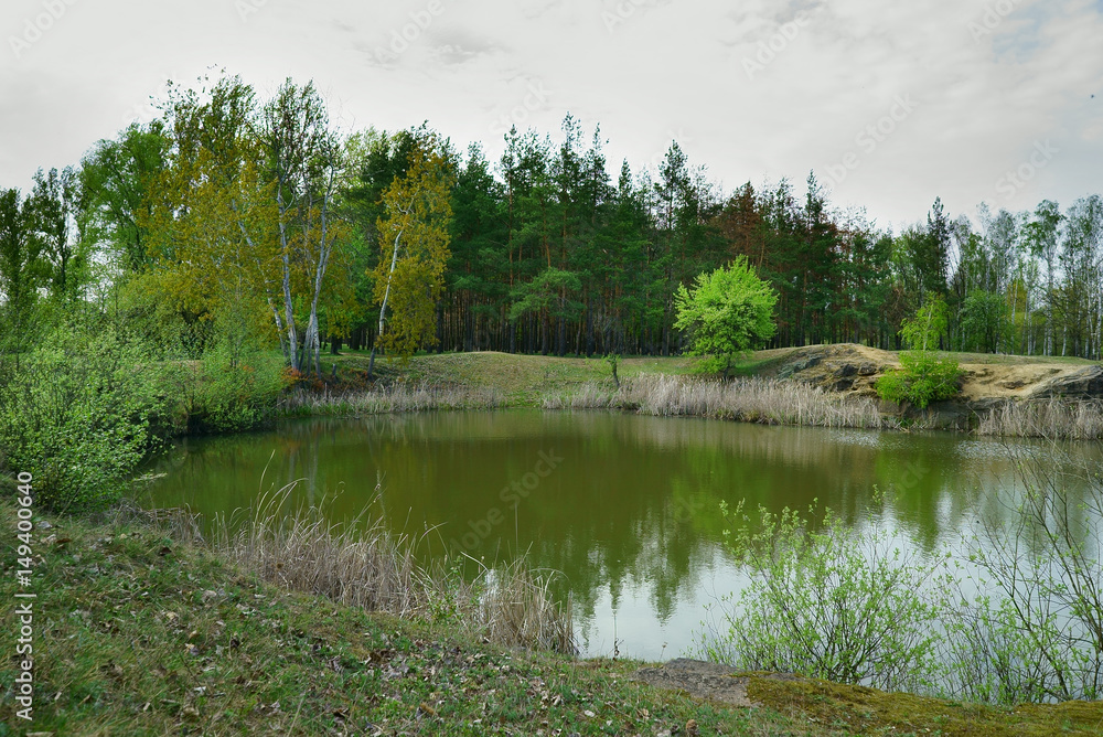 Lake in the forest. Old quarry for the extraction of granite