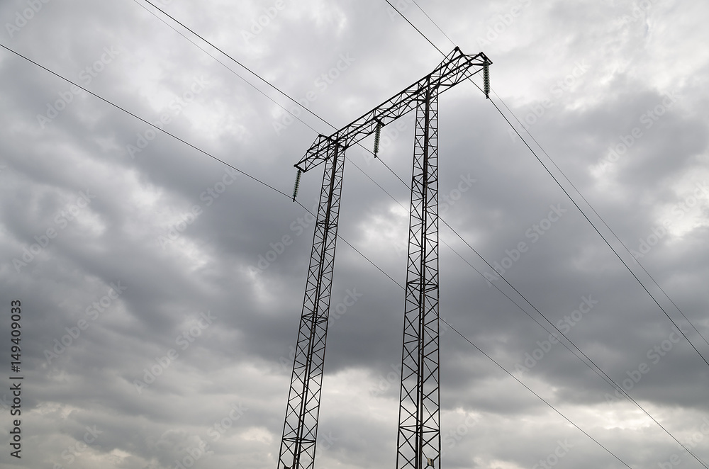 Electricity transmission pylon silhouetted against blue sky Electricity transmission pylon silhouetted against blue sky