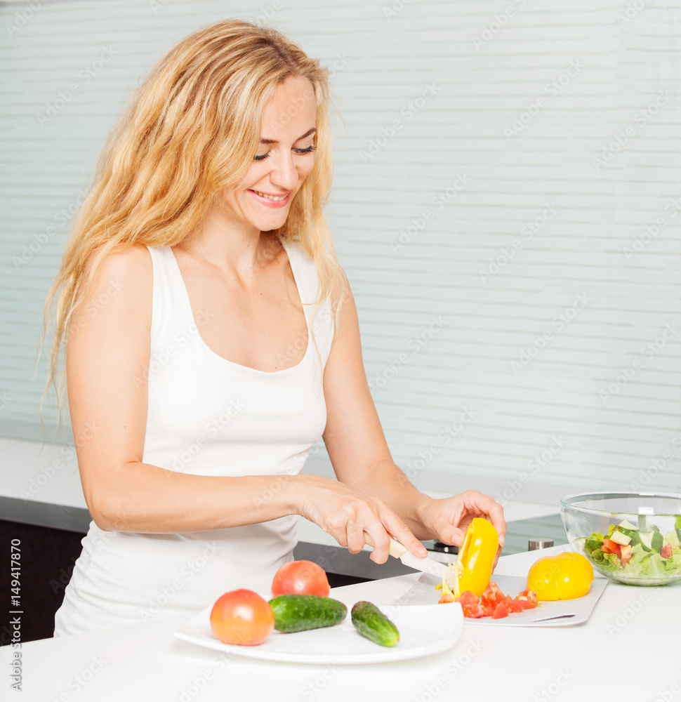 Young woman preparing vegetable salad Young woman preparing vegetable salad