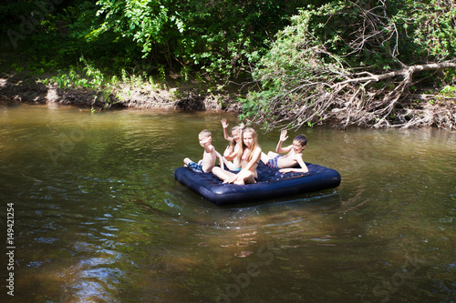 Children floating on the river