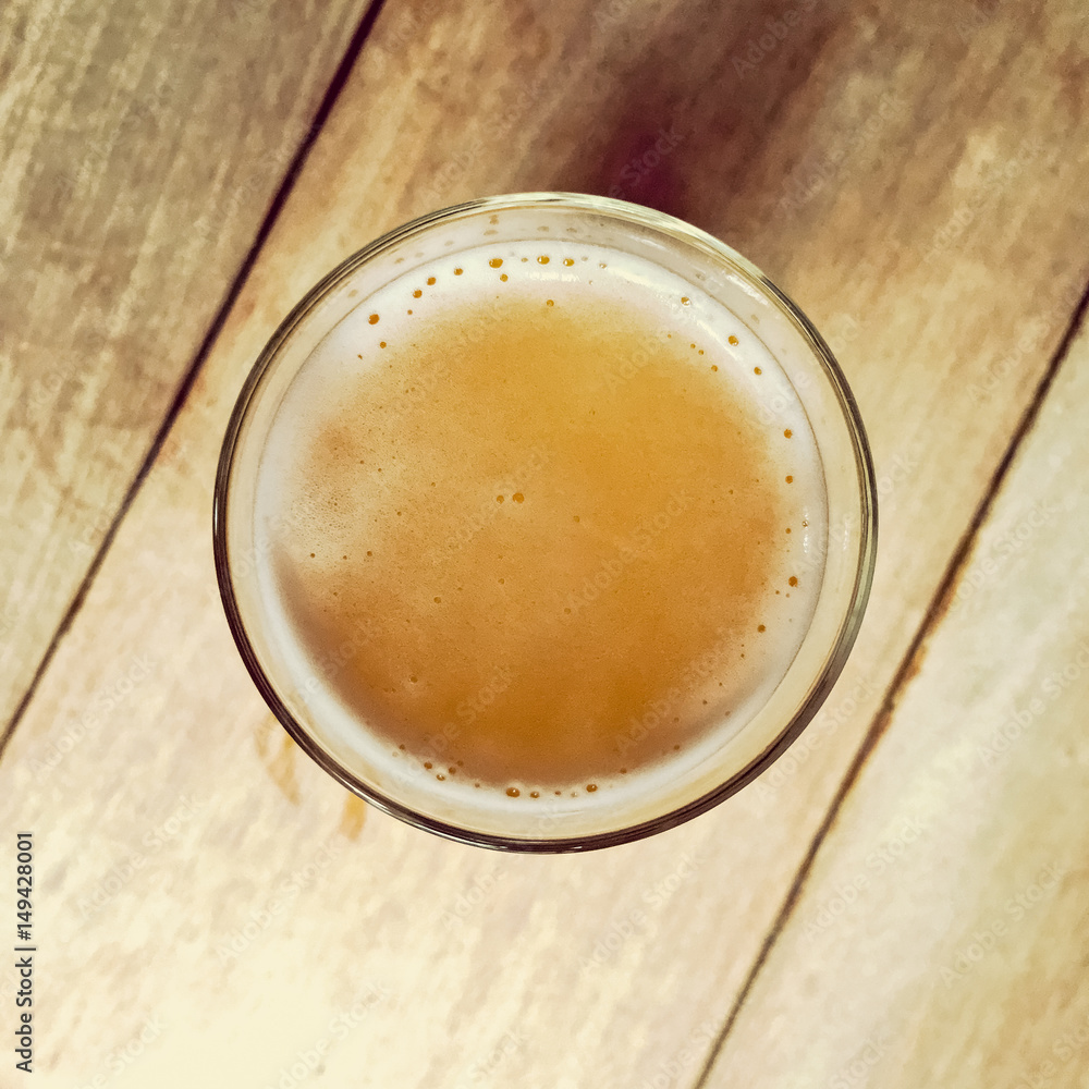 Glass of beer on a wooden bar table Glass of beer on a wooden bar table