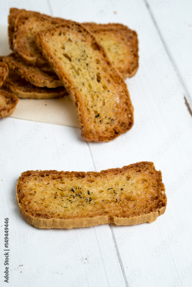 Slice of crostini on white background. A crostino is a small slice of toasted or grilled bread in Italian cuisine (appetizers). A versatile snack to eat plain, with vegetable, cheeses & meats! Slice of crostini on white background. A crostino is a small slice of toasted or grilled bread in Italian cuisine (appetizers). A versatile snack to eat plain, with vegetable, cheeses & meats!