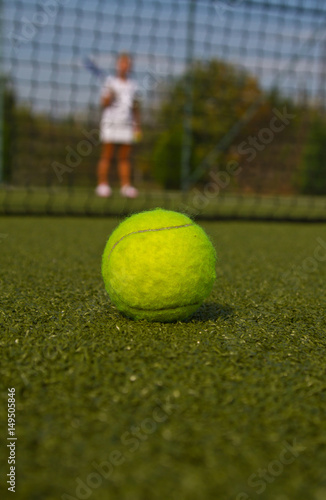Tennis ball and silhouette of tennis player © fototvv