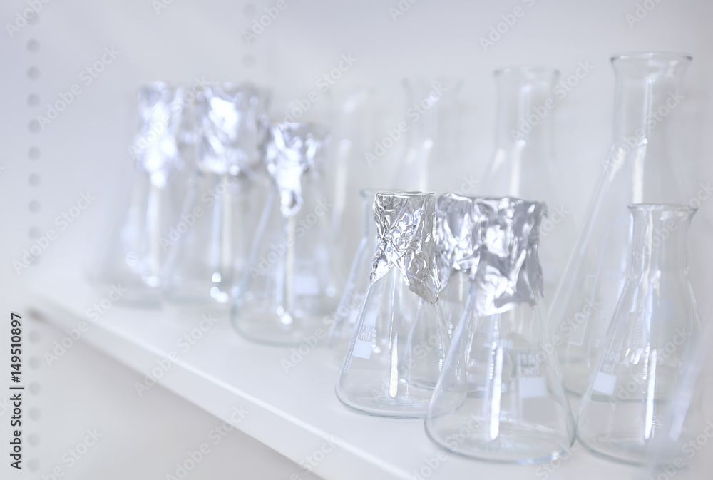 Conical flasks, shelf of clean laboratory glassware