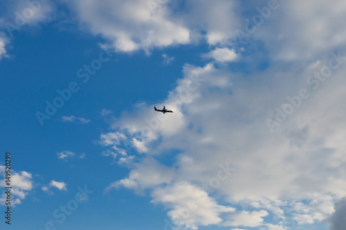 Airplane against blue sky with white clouds