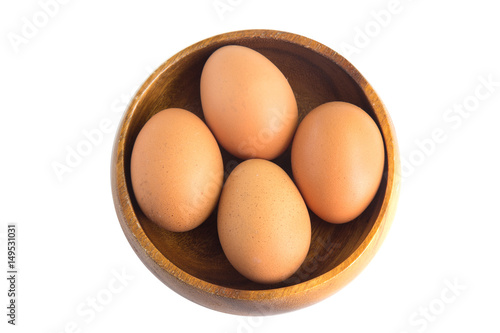 Egg in a wooden bowl isolated on white background.