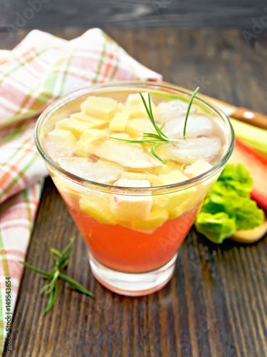Lemonade with rhubarb and rosemary on wooden table
