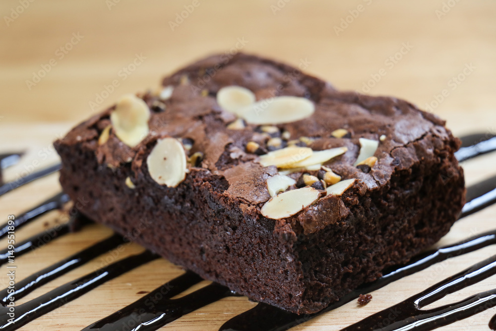 Closeup Piece of Brownies cake on wooden table. selective focus