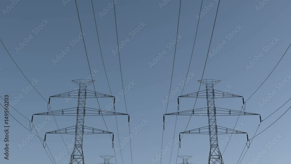 Pan of electrical power lines and pylons under sky. energy conservation conception. Electricity pylons and lines on a clear blue sky. loopable animation Pan of electrical power lines and pylons under sky. energy conservation conception. Electricity pylons and lines on a clear blue sky. loopable animation