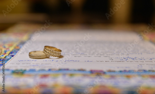 two wedding rings on a ketubah photo