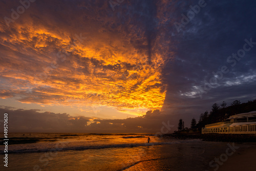 Fototapeta Naklejka Na Ścianę i Meble -  Sunrise Swim under Spectacular Clouds