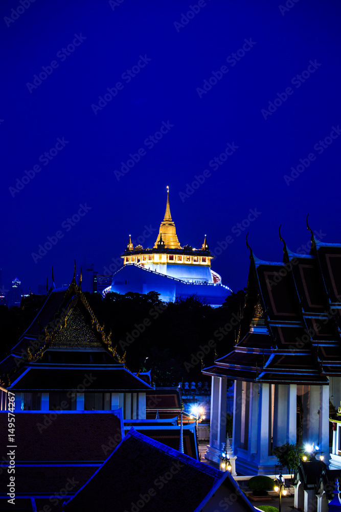 Golden mountain in Wat Saket Ratcha Wora Maha Wihan is a Buddhist temple in Bangkok, Thailand over night blue sky.