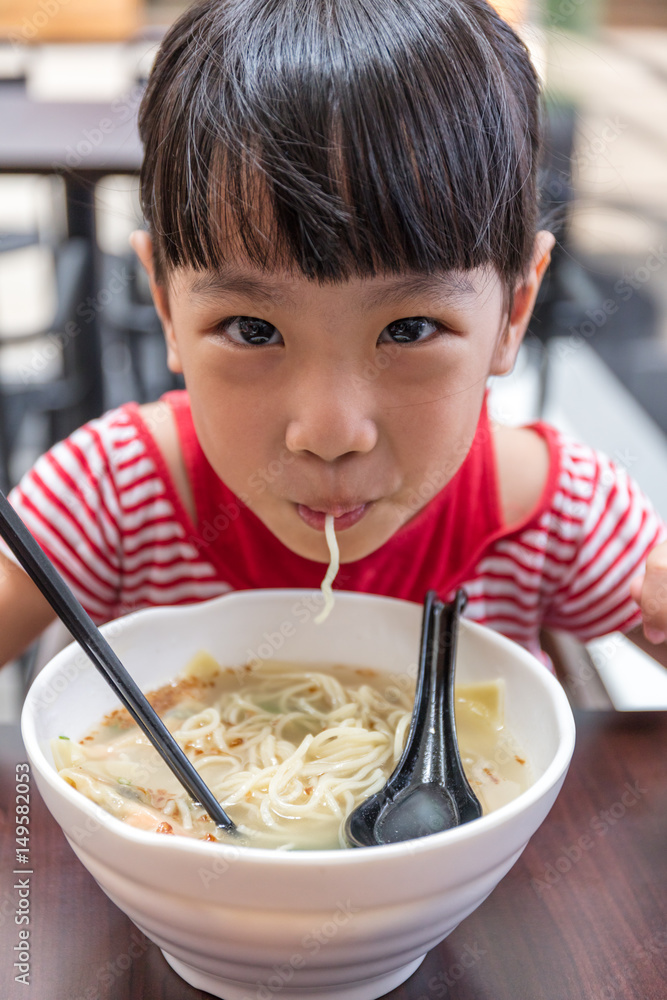 Asian little Chinese girl eating noodles soup Asian little Chinese girl eating noodles soup