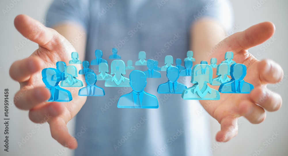 Businessman holding 3D rendering group of blue people Businessman holding 3D rendering group of blue people
