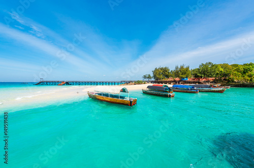 colorful exotic seascape with boats near Zanzibar shore in Africa photo