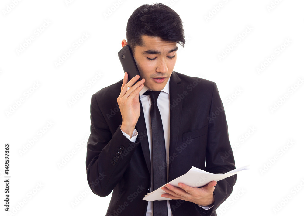 Young man in suit holding papers