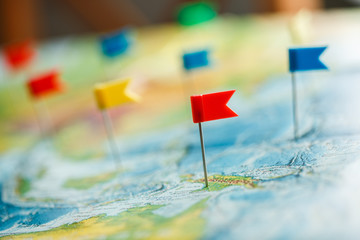Travel concept with flag pushpins and world map