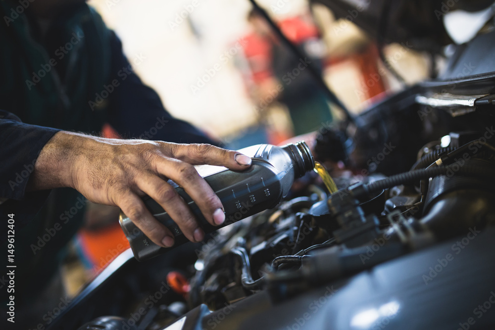 Close up hands of unrecognizable mechanic doing car service and maintenance. Oil and fuel filter changing. Close up hands of unrecognizable mechanic doing car service and maintenance. Oil and fuel filter changing.