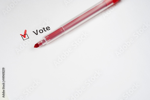 Questionnaire. Red marker and the inscription Vote with check mark on the white paper