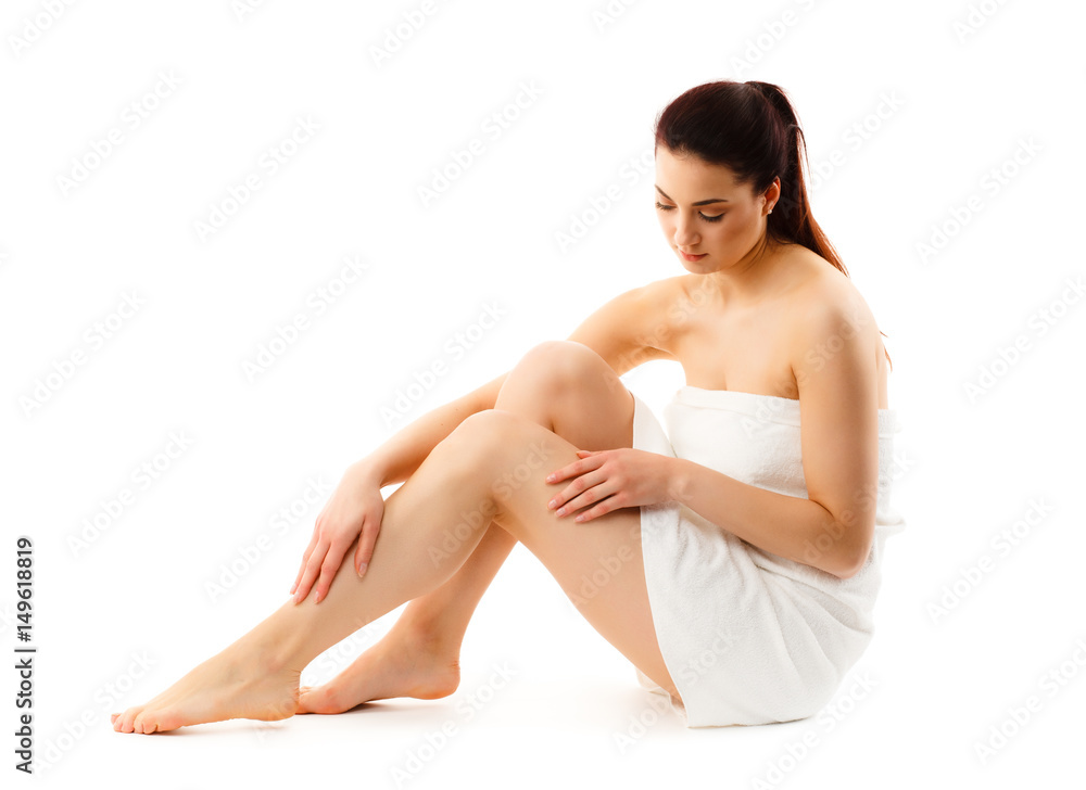 Woman massaging legs sitting on white background Woman massaging legs sitting on white background