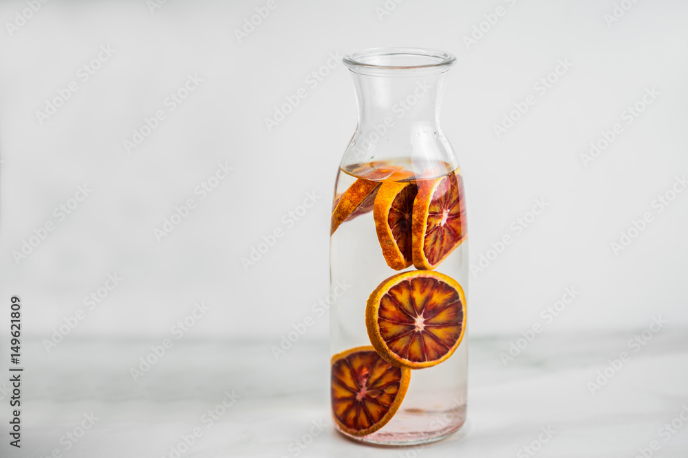 Jar of traditional red spanish sangria drink with different citrus fruits and mint over grunge wooden background. Selective focus Jar of traditional red spanish sangria drink with different citrus fruits and mint over grunge wooden background. Selective focus